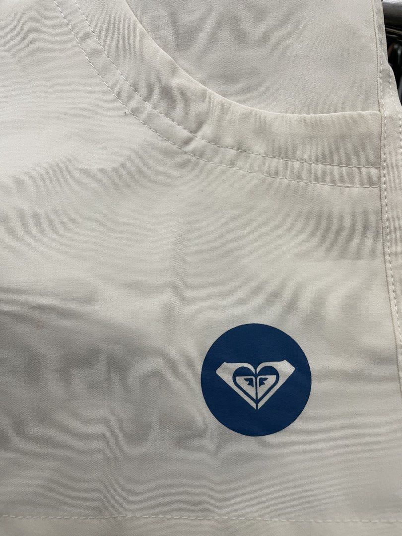 Roxy White Shorts with Logo (Category: Shorts) located in Lucena. Submitted by riyizthriftz (Listing ID 1463701474, Image 3). Description: - White Roxy shorts - Features Roxy logo on the back - Functional pockets - Button closure at the front - Small blue Roxy logo on the side.