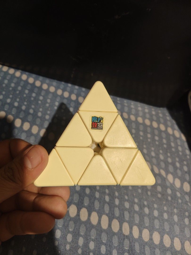 Rubik's Pyraminx Speed Cube (Category: Board Games & Puzzles) located in Mabalacat. Submitted by dam-sun (Listing ID 1463644402, Image 1). Description: - Smooth-moving Rubik's Pyraminx puzzle cube - Available in vibrant yellow and pastel blue/pink - Offers a fun and engaging challenge for puzzle enthusiasts of all ages - A great addition to any puzzle collection.
