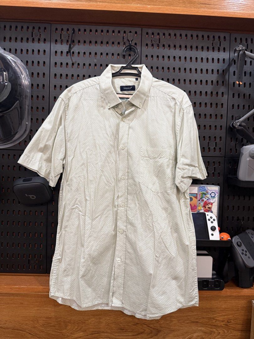 Sahara Short Sleeve Button Down Shirt (Category: Tshirts & Polo Shirts ) located in San Fernando. Submitted by archvst.selects (Listing ID 1463669102, Image 3). Description: - Sahara brand short sleeve button down shirt - Light beige color with subtle checkered pattern - Features a chest pocket - Classic collar design - Versatile for casual or smart-casual outfits - Easy to pair with shorts or pants Note: Item are personal preloved. Used once. Be