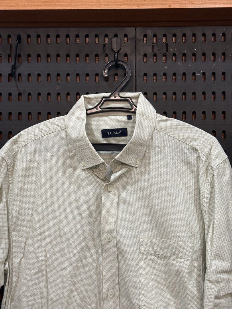 Sahara Short Sleeve Button Down Shirt (Category: Tshirts & Polo Shirts ) located in San Fernando. Submitted by archvst.selects (Listing ID 1463669102, Image 2). Description: - Sahara brand short sleeve button down shirt - Light beige color with subtle checkered pattern - Features a chest pocket - Classic collar design - Versatile for casual or smart-casual outfits - Easy to pair with shorts or pants Note: Item are personal preloved. Used once. Be