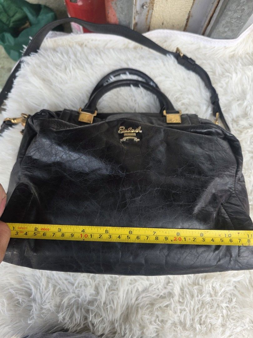Salad Black Leather Handbag (Category: Shoulder Bags) located in Lemery. Submitted by venus23 (Listing ID 1463740153, Image 3). Description: - Genuine black leather handbag by Salad - Versatile with top handles and a detachable shoulder strap - Elegant gold hardware details - Shows natural creasing, characteristic of leather - Spacious interior, ideal for everyday essentials.