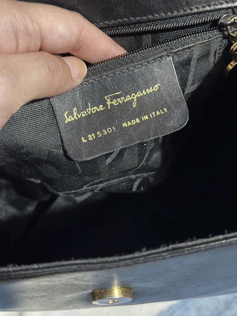 Salvatore Ferragamo Black Leather Top Handle Bag (Category: Luxury Bags & Wallets) located in Makati City. Submitted by love003xx (Listing ID 1463660709, Image 2). Description: - Classic black leather handbag by Salvatore Ferragamo - Features iconic ribbon detail with gold accent - Interior zip pocket for organization - Detachable strap for shoulder or crossbody wear - Made in Italy - Versatile for everyday use or special occasions.