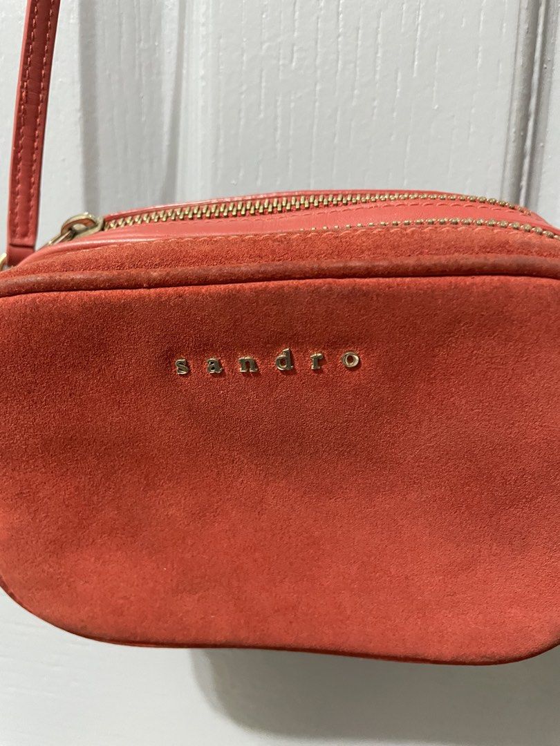 Sandro Red Suede Leather Crossbody Bag (Category: Cross-body Bags) located in Dagupan City. Submitted by fahionista1988 (Listing ID 1463681773, Image 1). Description: - Cute red crossbody bag from Sandro - Made with suede and leather - Features two zippered compartments - Elegant gold hardware details - Adjustable strap for comfort - Versatile for everyday use or a night out.