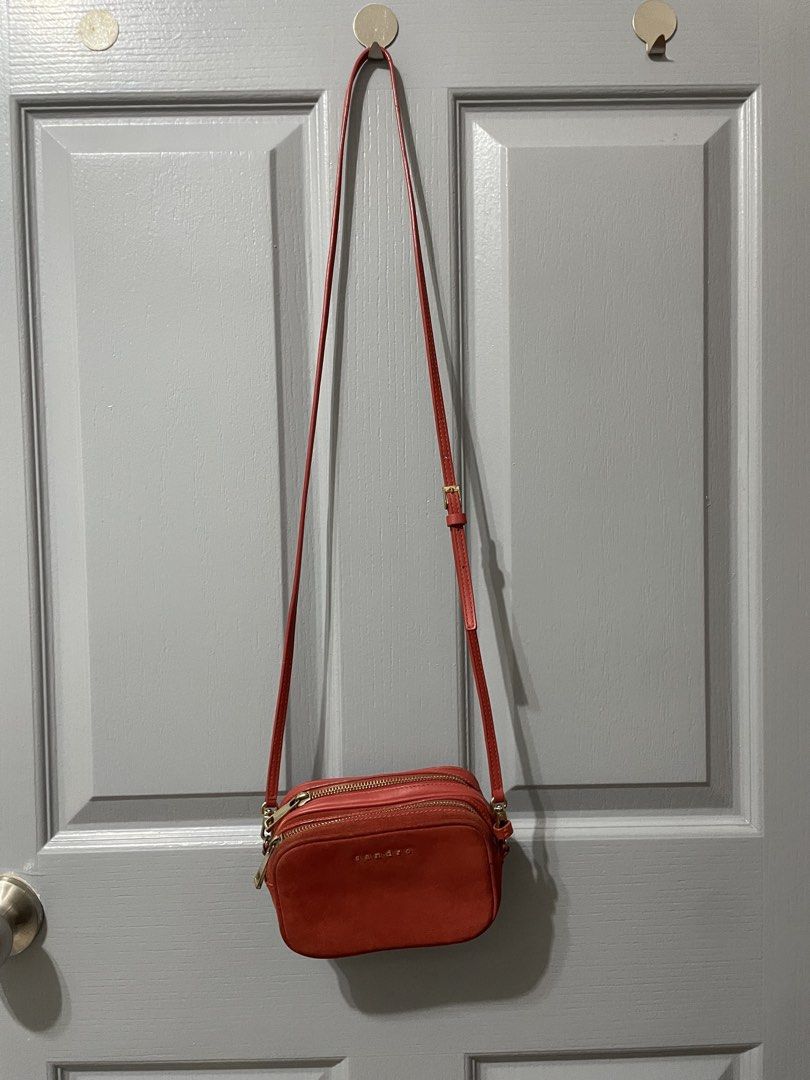 Sandro Red Suede Leather Crossbody Bag (Category: Cross-body Bags) located in Dagupan City. Submitted by fahionista1988 (Listing ID 1463681773, Image 3). Description: - Cute red crossbody bag from Sandro - Made with suede and leather - Features two zippered compartments - Elegant gold hardware details - Adjustable strap for comfort - Versatile for everyday use or a night out.