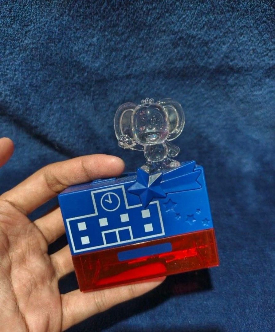 Sanrio Hello Kitty Pencil Sharpener with Toy Figure (Category: Stationery & School Supplies) located in Manila. Submitted by kirstentoyshub (Listing ID 1463660684, Image 2). Description: - Adorable Kitty pencil sharpener - Features a clear Kitty figure on top - Fun blue and red casing with star and clock designs - Convenient shavings compartment - Works with standard pencils - Ideal for Kitty fans, kids' stationery, or collectors.