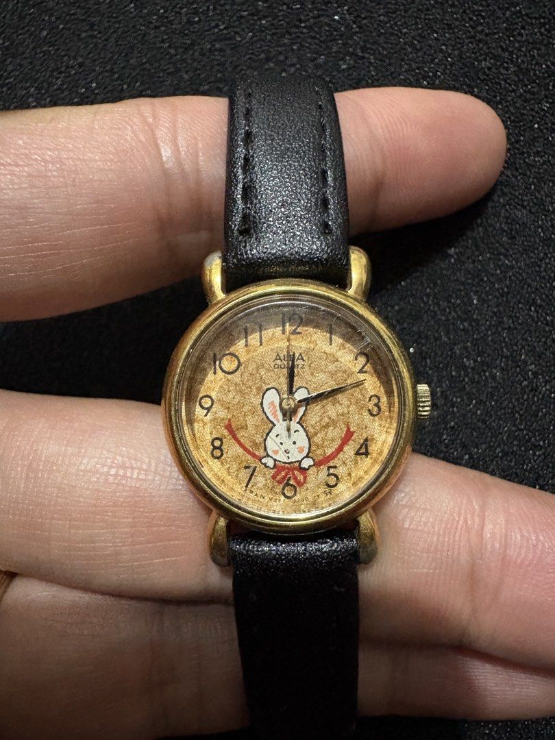 Seiko Alba Quartz (Category: Women's Watches) located in Quezon City. Submitted by rentoti (Listing ID 1463568456, Image 2). Description: - Brand: Seiko Alba - Movement: Quartz - Design: Features a charming bunny graphic on the dial - Case: Gold-tone - Strap: Black leather - Condition: Pre-loved, with visible signs of wear - Origin: Japan (as indicated on the case back).
