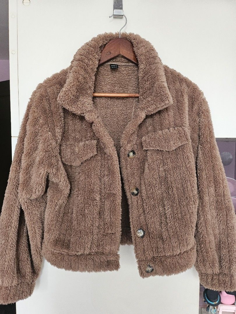 SHEIN Brown Fuzzy Autumn/Fall Jacket (Category: Coats, Jackets and Outerwear) located in Taguig. Submitted by ynalorenzo (Listing ID 1463620834, Image 1). Description: - Super soft and cozy brown fuzzy jacket - Brand: SHEIN - Features: Button-up front, two chest pockets - Ideal for layering in cold weather - Comfortable and stylish.