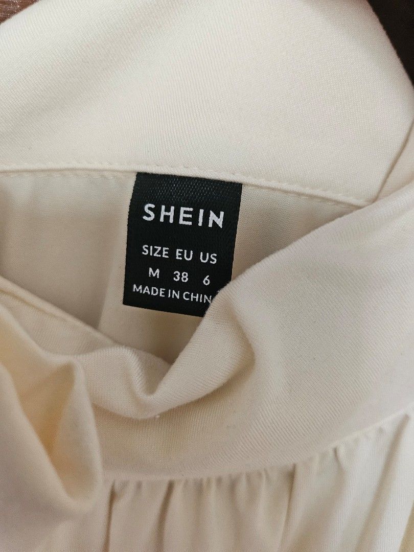SHEIN Cream Ruched Neck Ribbon Top (Category: Blouses) located in Taguig. Submitted by ynalorenzo (Listing ID 1463620118, Image 2). Description: - SHEIN cream top - Features a ruched neckline with a tie detail - Made from a soft, comfortable fabric.