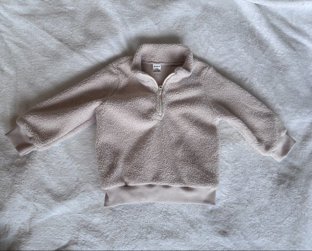 SHEIN Kids Fleece Half-Zip Pullover (Category: Babies & Kids Fashion) located in Quezon City. Submitted by issawoah (Listing ID 1463602512, Image 3). Description: - Super cozy fleece pullover for kids - Features a half-zip neckline - Soft and fuzzy texture for ultimate comfort - Ribbed cuffs and hem for a snug, secure fit - Ideal for keeping warm on cooler days - Easy to layer over t-shirts - Perfect for everyday wear - 12 to 18 months on tag.