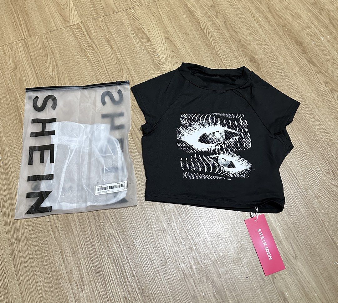 SHEINCON Black Graphic Crop Top (Category: Shirts) located in Makati City. Submitted by ferl-xx (Listing ID 1463568301, Image 1). Description: - Chic black crop top - Brand new, never worn - Small.