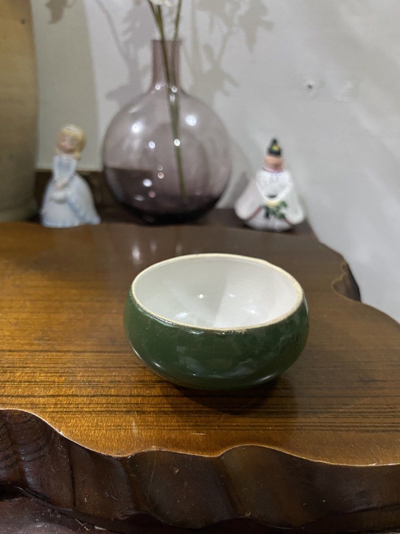 Small Green Ceramic Bowl (Category: Vases & Decorative Bowls) located in Taguig. Submitted by minmin_parker (Listing ID 1463696811, Image 1). Description: - Adorable small green bowl - Smooth, glossy green glaze on the outside - Clean white interior - Ideal for holding trinkets, jewelry, or as a small serving dish - Adds a vibrant pop of color to shelves and decor - Perfect for collectors of small decorative items.