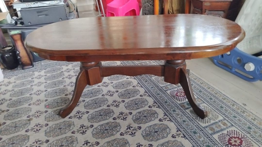 Solid Wood Coffee Table (Category: Tables & Sets) located in Kuala Lumpur. Submitted by amirulfik93 (Listing ID 1463700542, Image 1). Description: Solid wood oval coffee table. Dark brown wood finish. Sturdy pedestal base with curved legs. Some minor scuffs on the surface from normal use. Approx. 110cm x 60cm x 45cm(H) Self pickup from Taman Melati.