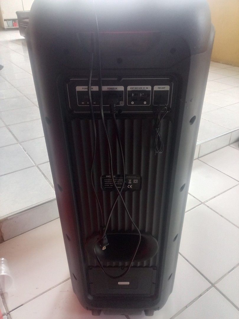 Speaker (Category: Soundbars, Speakers & Amplifiers) located in Manila. Submitted by markie08 (Listing ID 1463642850, Image 3). Description: Portable Switch Bluetooth Speaker Large black/gray portable speaker with a tall rectangular body. Has two large speaker drivers on the front. The front has green LED lights surrounding the speakers. A Switch logo is visible in the center. The back has connections labeled POWER IN, EXT DC 12V IN, and FM ANT. 