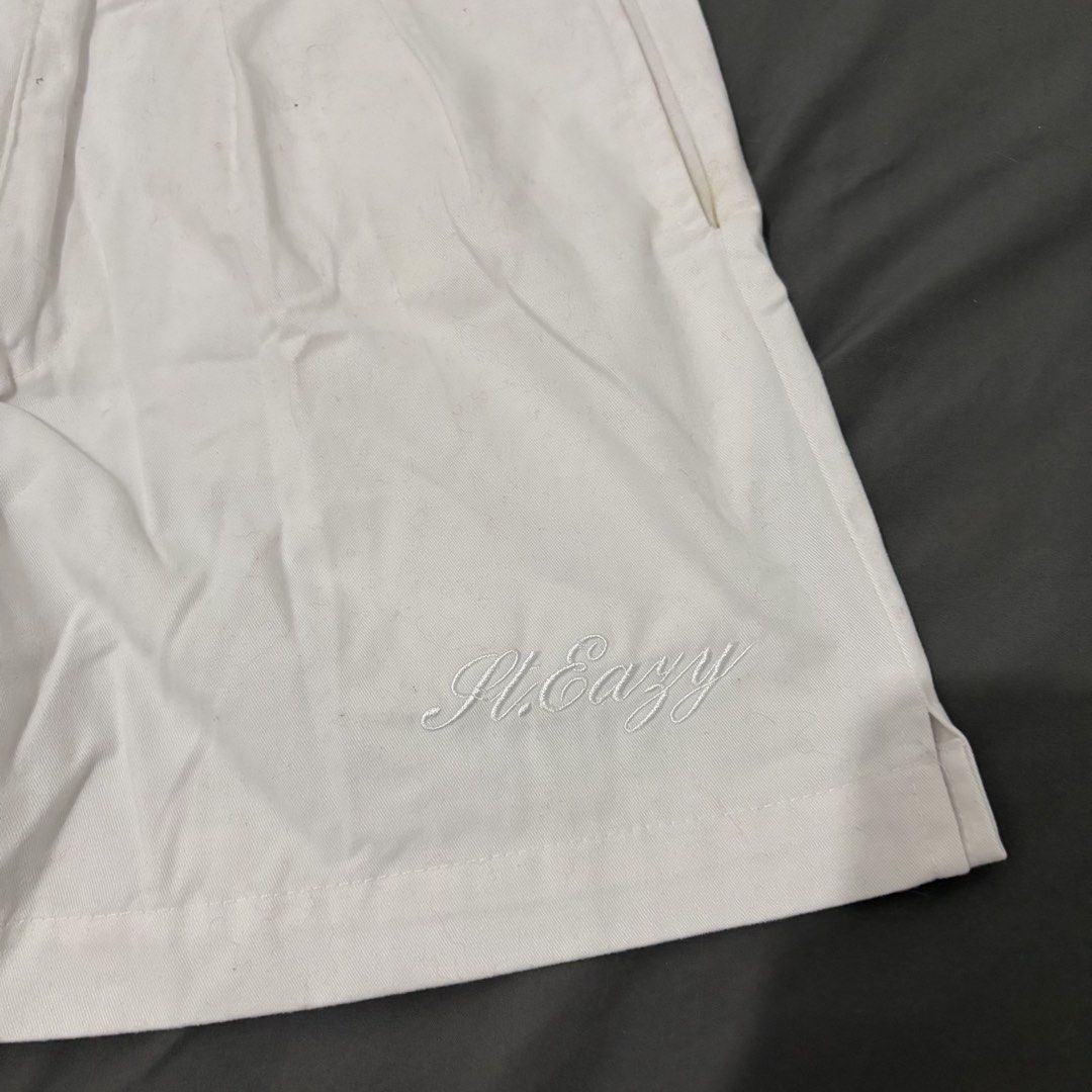 St. Eazy White Pleated Shorts Size L (Category: Shorts) located in Makati City. Submitted by sseurekiii (Listing ID 1463721178, Image 2). Description: - Brand: St. Easy - Color: White - Style: Pleated Shorts - Size: Large - Features: Embroidered St. Easy logo on left leg, two buttoned back pockets - Closure: Classic button and zip front - Occasion: Great for casual wear.