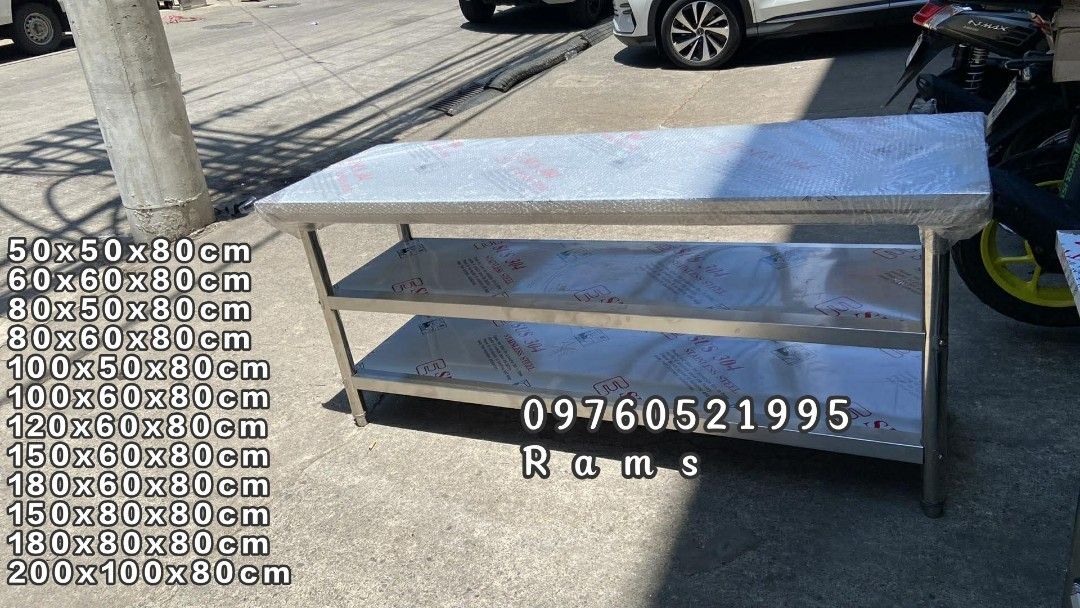 Stainless Steel Work Table with Shelves - Various Sizes Available (Category: Tables & Sets) located in Manila. Submitted by acykt18 (Listing ID 1463723974, Image 2). Description: - Heavy duty stainless steel construction - Ideal for kitchen or workshop environments - Includes two shelves for ample storage - Available in various sizes - Durable and easy to maintain - Contact us for specific dimensions and pricing.