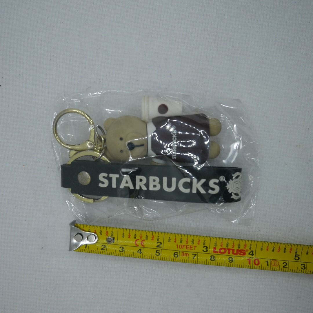 Starbucks Bear/bearista with Coffee Cup Keychain with hand strap (Category: Character Goods) located in Valenzuela. Submitted by cletini (Listing ID 1463701019, Image 2). Description: Cute Starbucks bear keychain holding a coffee cup, paired with a black Starbucks logo strap. Great for bags, keys or as a collectible accessory. ☕🐻 📌 Material: Rubber/PVC bear figure + metal hardware 📌 Includes key ring & lobster clasp 📌 Approx. 3–4" overall len