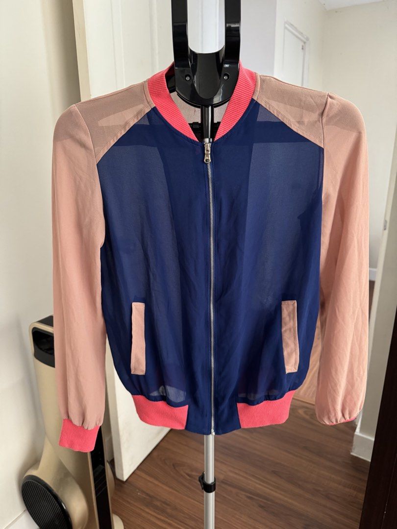 Stradivarius Colorblock Sheer Bomber Jacket M (Category: Coats, Jackets and Outerwear) located in Rizal. Submitted by thrifty.mom (Listing ID 1463657982, Image 1). Description: - Brand: Stradivarius - Style: Colorblock Bomber Jacket - Color: Navy blue (sheer front/back) with light pink sleeves/accents - Features: Ribbed cuffs & hem, zip-up front, pockets - Size: Medium (M) - Occasion: Casual wear, layering.