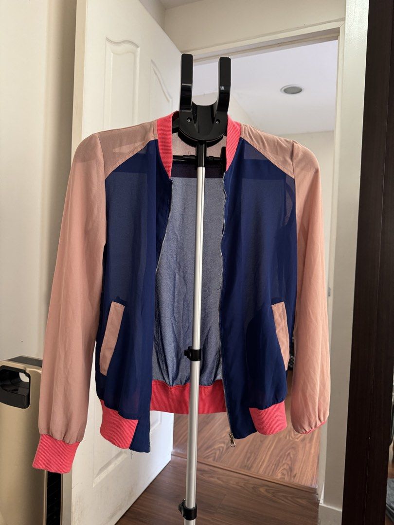 Stradivarius Colorblock Sheer Bomber Jacket M (Category: Coats, Jackets and Outerwear) located in Rizal. Submitted by thrifty.mom (Listing ID 1463657982, Image 2). Description: - Brand: Stradivarius - Style: Colorblock Bomber Jacket - Color: Navy blue (sheer front/back) with light pink sleeves/accents - Features: Ribbed cuffs & hem, zip-up front, pockets - Size: Medium (M) - Occasion: Casual wear, layering.