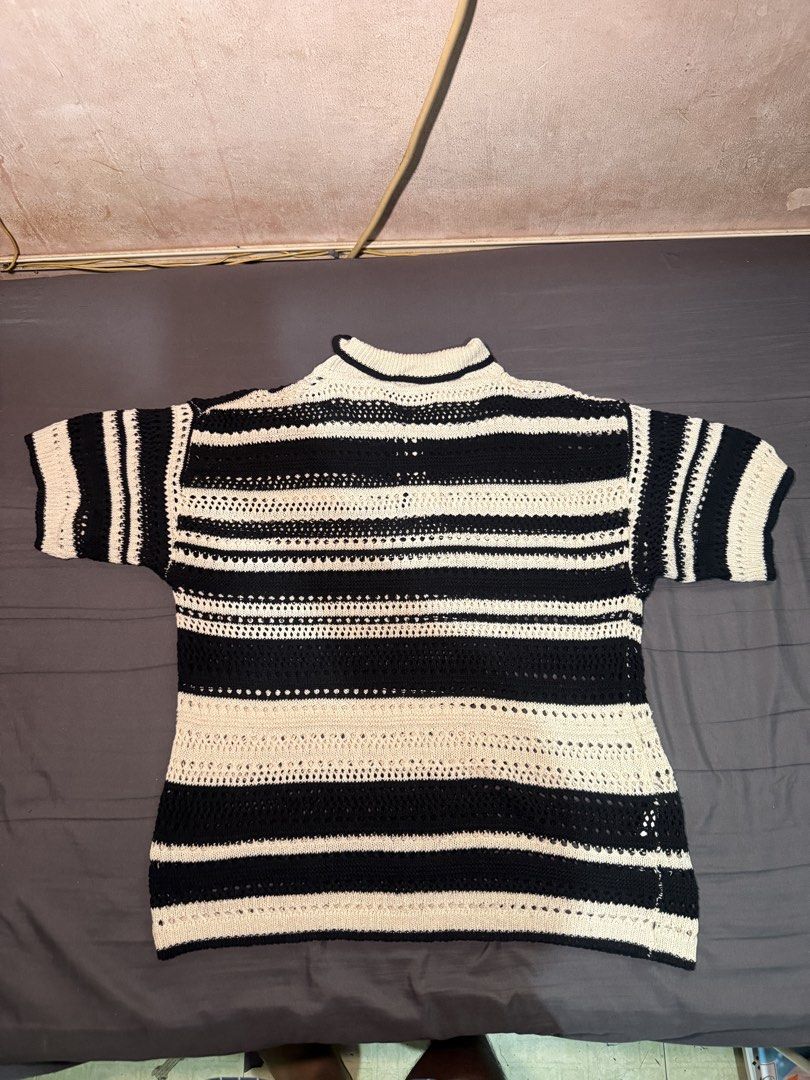 Striped Crochet Polo Shirt (Category: Tshirts & Polo Shirts ) located in Marikina City. Submitted by emmanasamy (Listing ID 1463624649, Image 2). Description: - Stylish black and white striped crochet polo shirt. - Short sleeves with a classic collar and button closure. - Unique open knit detailing for a textured look. - Versatile for layering or wearing solo. - Offers a casual and comfortable vibe. Used once Rfs: Declutter.
