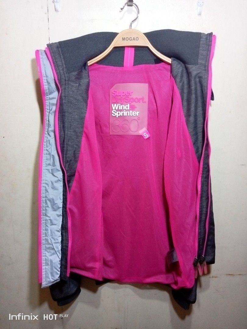 Superdry Sport Wind Sprinter 360 Jacket (Category: Coats, Jackets and Outerwear) located in Manila. Submitted by rhegsthrifted (Listing ID 1463679679, Image 3). Description: - Superdry Sport Wind Sprinter 360 Jacket - Size: S - Dimes : Width - 19.5 x Length - 29 - Condition : Excellent Good Condition - Color: Grey with vibrant pink accents and lining - Features: Hood, zip-up front, two zip pockets - Ideal for: Outdoor activities and sports 💵 Pri
