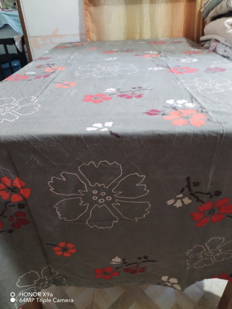 Table Topper 6 seaters (Category: Table Linen & Textiles) located in Muntinlupa City. Submitted by arciagamaryann68 (Listing ID 1463612593, Image 2). Description: - Table topper designed for 6-seater tables. - Features a stylish grey background with a floral pattern. - Floral design includes colors like red, orange, and white. - Adds a decorative touch to your dining table. - Suitable for everyday use or special occasions..