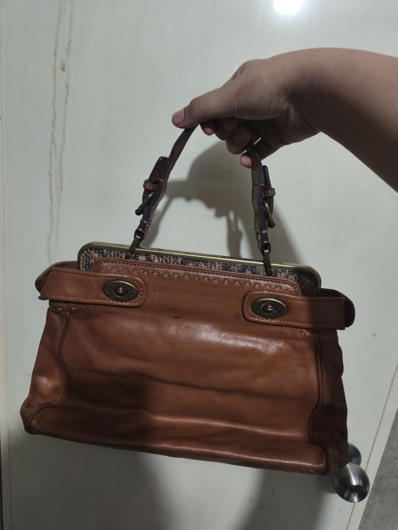 Talbots Brown Leather Handbag (Category: Shoulder Bags) located in Plaridel. Submitted by julleyuuuh (Listing ID 1463592428, Image 1). Description: - Brand: Talbots - Material: Brown Leather - Closure: Clasp - Handles: Top handles - Interior: Snake print lining - Condition: Some signs of wear on the leather - Best for: Everyday use.