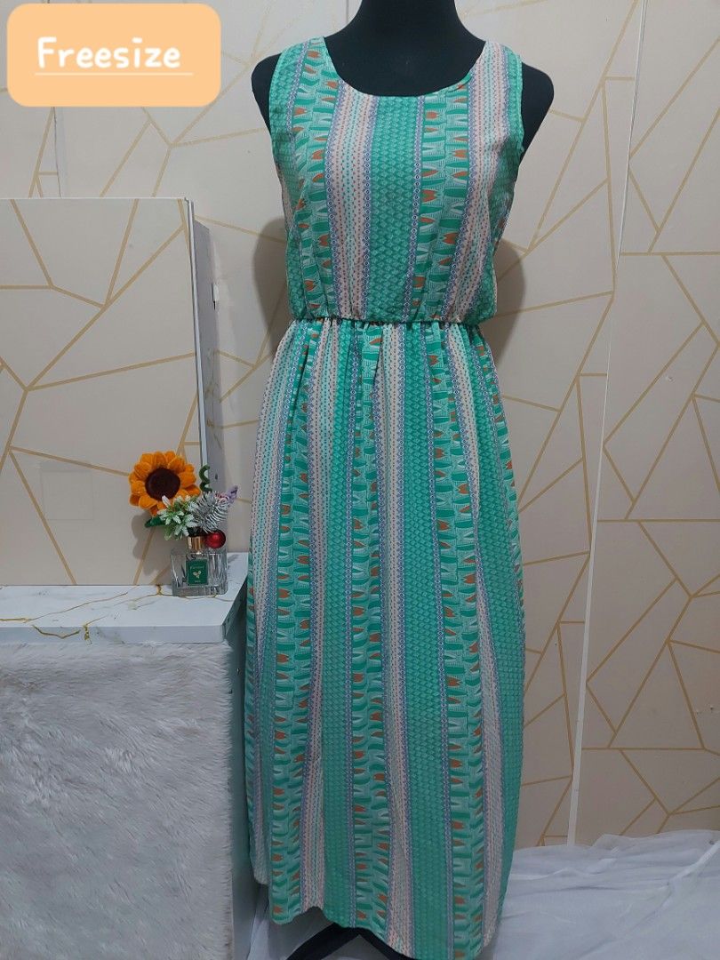 Teal Geometric Print Maxi Dress (FREESIZE) (Category: Dresses) located in Manila. Submitted by jollyann_b1990 (Listing ID 1463643154, Image 1). Description: - Freesize maxi dress - Teal base with white, orange, and blue geometric print - Cinched waist for a flattering fit - Sleeveless design - Comfortable round neckline - Ideal for casual outings or beach days - Easy to wear and very comfortable.