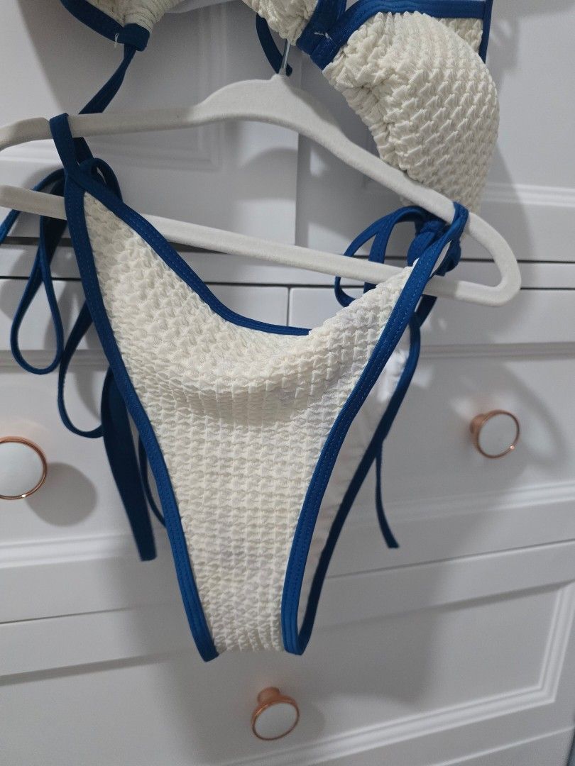 Textured White Bikini with Blue Trim (Category: Bikinis & Swimsuits) located in Arayat. Submitted by polenbi15 (Listing ID 1463582493, Image 2). Description: - Cute textured bikini set - White with contrasting blue trim - Adjustable ties at neck and back - Adds a nice detail with its texture - Great for beach or pool - Ready for your next vacation.