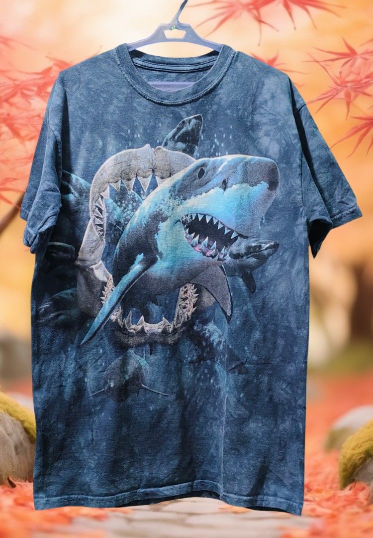 The Mountain T-shirt - Shark Attack Graphic Tee (Category: Tshirts & Polo Shirts ) located in Camiling. Submitted by sundot_kalikot (Listing ID 1463704686, Image 1). Description: - Brand: The Mountain - Design: Detailed shark attack with multiple sharks - Effect: Unique tie-dye pattern - Style: Short sleeves, classic crew neck - Material: Comfortable fabric - Ideal for: Ocean life enthusiasts, fans of bold prints.