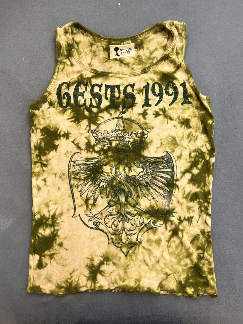 Tie-dye graphic ribbed tank top (Category: Sleeveless) located in San Jose. Submitted by thymies (Listing ID 1463651232, Image 1). Description: Can fit small-med ‼️COLOR MAY VARY DUE TO LIGHTING‼️ Style: Fitted ribbed tank top / sleeveless tee Pattern & Color: Olive green and cream acid-wash / tie-dye effect Graphic: Crest coat of arms with a crowned eagle and gothic lettering (“GESTS 1991”) Aesthetic: Y2K Grunge / Alt / Vintage streetwear.