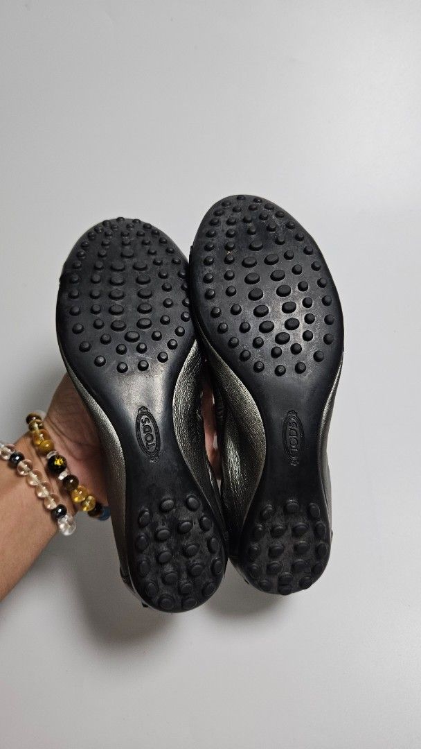 TOD'S Metallic Leather Ballet Flats (Category: Flats & Sandals) located in Alfonso. Submitted by jbcamet (Listing ID 1463677243, Image 3). Description: - TOD'S ballet flats - Metallic pewter color - Made from soft leather - Iconic rubber pebble sole - Small buckle detail on strap - Size 35.5 - Ideal for everyday wear.