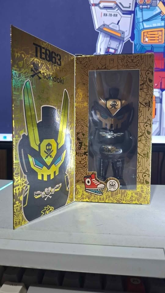 Tokidoki TE063 Quiccs Black Tiger (Category: Designer & Blind Box Toys) located in Imus. Submitted by ToyBlazePH (Listing ID 1463611386, Image 2). Description: - Tokidoki TE063 designer toy - Black and gold colorway - Features a skull motif - Comes in original packaging - Unique robotic/skull figure design - Box has cool camouflage and skull graphics - Perfect for collectors.