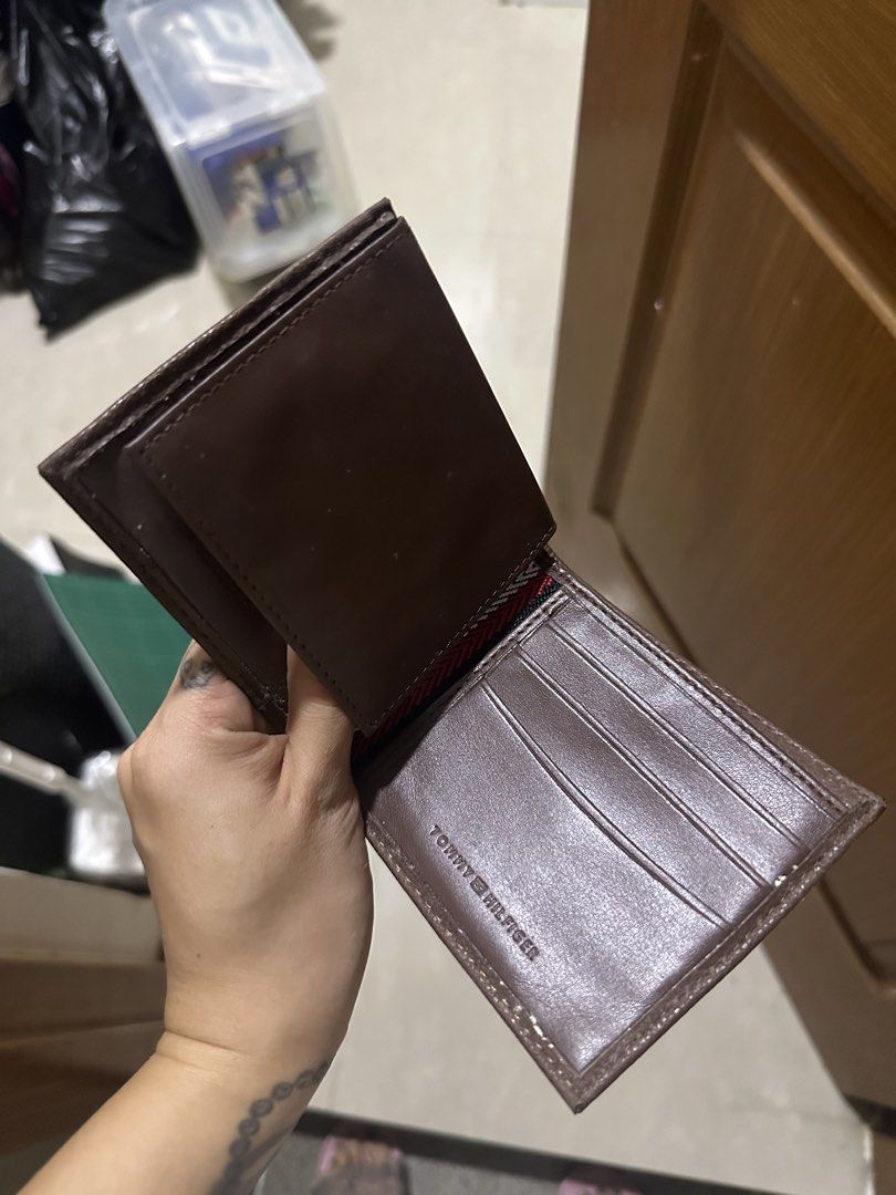 Tommy Hilfiger Brown Leather Bifold Wallet (Category: Wallets & Card Holders) located in Mandaluyong City. Submitted by prelovedbytim (Listing ID 1463675783, Image 2). Description: - Genuine Tommy Hilfiger brown leather bifold wallet. - Multiple card slots for organization. - Textured exterior with embossed 'H' logos. - Signature small Tommy Hilfiger flag logo on the front. - Ideal for everyday carry. Di po nagamit natambak lang.