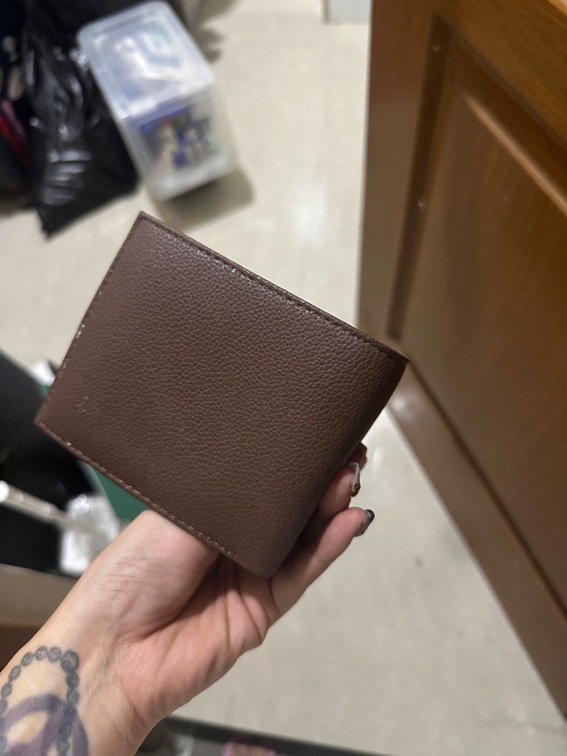 Tommy Hilfiger Brown Leather Bifold Wallet (Category: Wallets & Card Holders) located in Mandaluyong City. Submitted by prelovedbytim (Listing ID 1463675783, Image 3). Description: - Genuine Tommy Hilfiger brown leather bifold wallet. - Multiple card slots for organization. - Textured exterior with embossed 'H' logos. - Signature small Tommy Hilfiger flag logo on the front. - Ideal for everyday carry. Di po nagamit natambak lang.