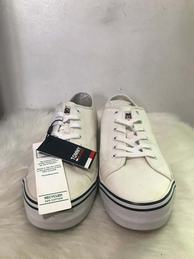 Tommy Jeans White Canvas Sneakers (Category: Sneakers) located in Manila. Submitted by vincent.seller (Listing ID 1463621994, Image 1). Description: - White canvas sneakers from Tommy Jeans - Classic lace-up style - Features iconic Tommy flag logo on side and tongue - Soles with stylish black and red stripe detail - Crafted with 50% recycled cotton - Ideal for casual and everyday wear.