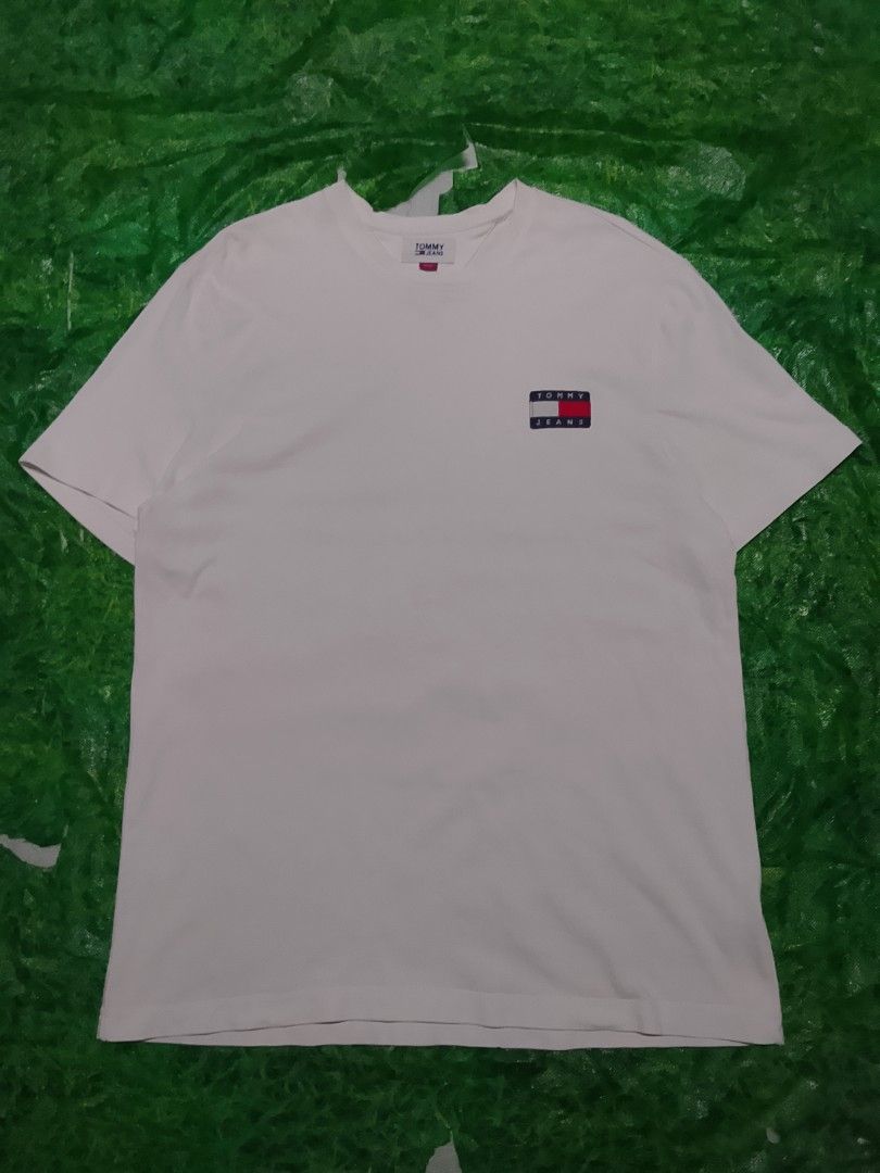 Tommy jeans white tee (Category: Formal Shirts) located in Tagbina. Submitted by jera-thrift.16 (Listing ID 1463681164, Image 1). Description: good condition color rate 9/10 dimes 21.5x29 no issues need wash.