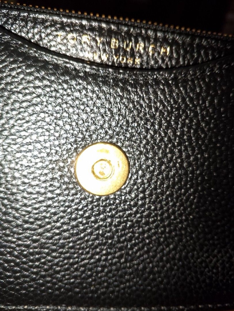 Tory Burch Black Leather Handbag with Gold Chain (Category: Luxury Bags & Wallets) located in Bacolor. Submitted by pinktintmine (Listing ID 1463639550, Image 3). Description: - Authentic Tory Burch black leather handbag - Signature gold logo on the front - Top handle and detachable gold chain strap with leather accents - Secure magnetic snap closure - Interior features Tory Burch New York branding - Small and compact size, perfect for essentials