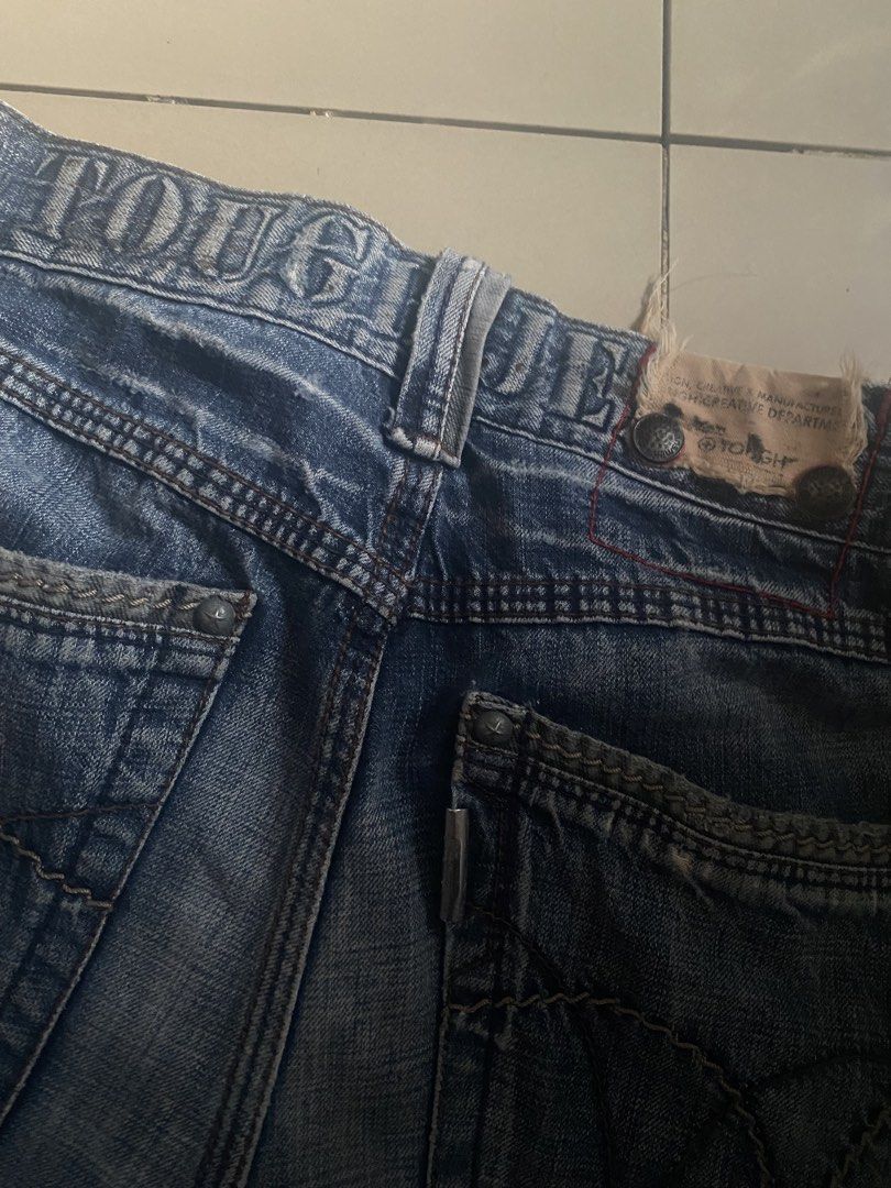 Tough Jeansmith Denim Jeans (Category: Jeans) located in Quezon City. Submitted by beepboop2506 (Listing ID 1463735040, Image 3). Description: - Tough Jeansmith distressed denim jeans - Classic blue wash with fading and whiskering - Straight leg fit - Button fly closure - Unique stitching and pocket detail.