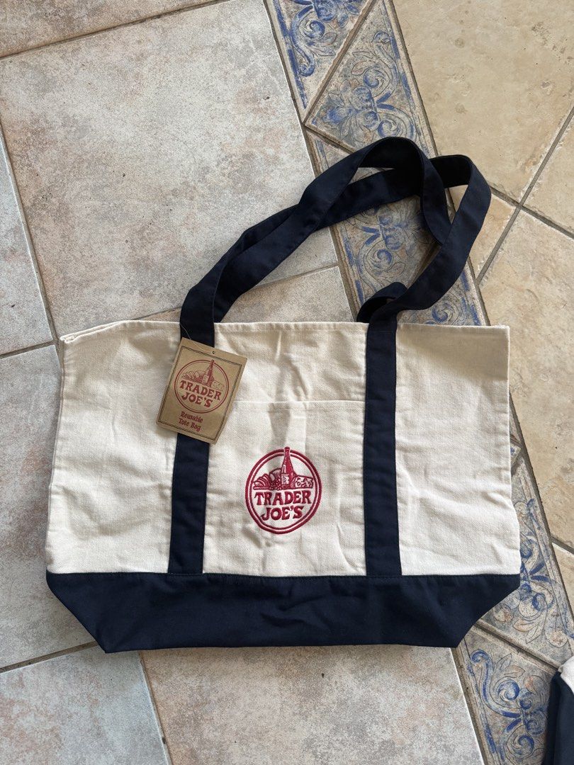 Trader Joe's Reusable Canvas Tote Bag (Category: Tote Bags) located in Taytay. Submitted by phoebspreloved (Listing ID 1463575812, Image 1). Description: - Trader Joe's reusable tote bag - Classic Trader Joe's logo embroidered on the front - Ideal for groceries or everyday use - Durable and eco-friendly design.
