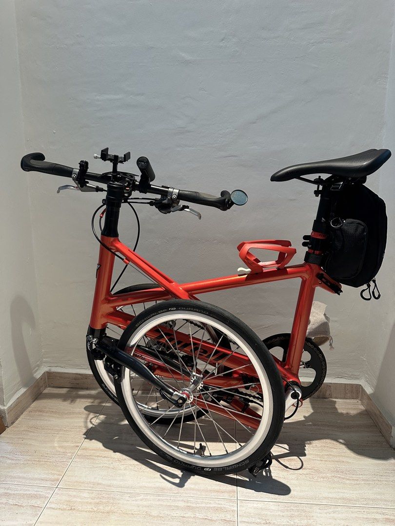 Tyrell FX (Category: Bicycles) located in Singapore. Submitted by v8craz (Listing ID 1463684191, Image 2). Description: A bright orange Tyrell FX folding bike impresses with - 20-inch wheels - a stylish aluminum X-frame - weighs about 7-8kg with its 10-speed Shimano Tiagra gears - special grips.