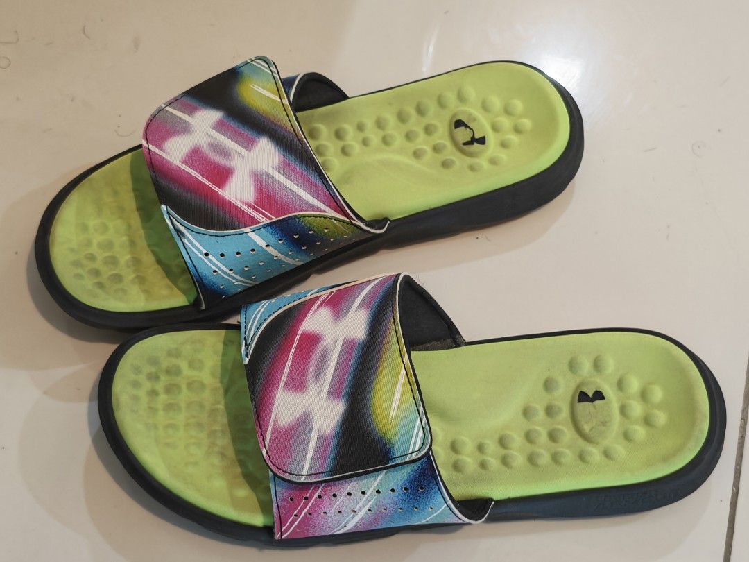 Under Armour Slippers (Avail before 9/29) (Category: Slippers & Slides) located in Manila. Submitted by oddowl-a357 (Listing ID 1463686904, Image 1). Description: - Under Armour slides - Vibrant multi-color strap - Neon green footbed with textured grip - Easy slip-on style - Perfect for casual wear or after sports - Shows some signs of wear, but still has plenty of life left.