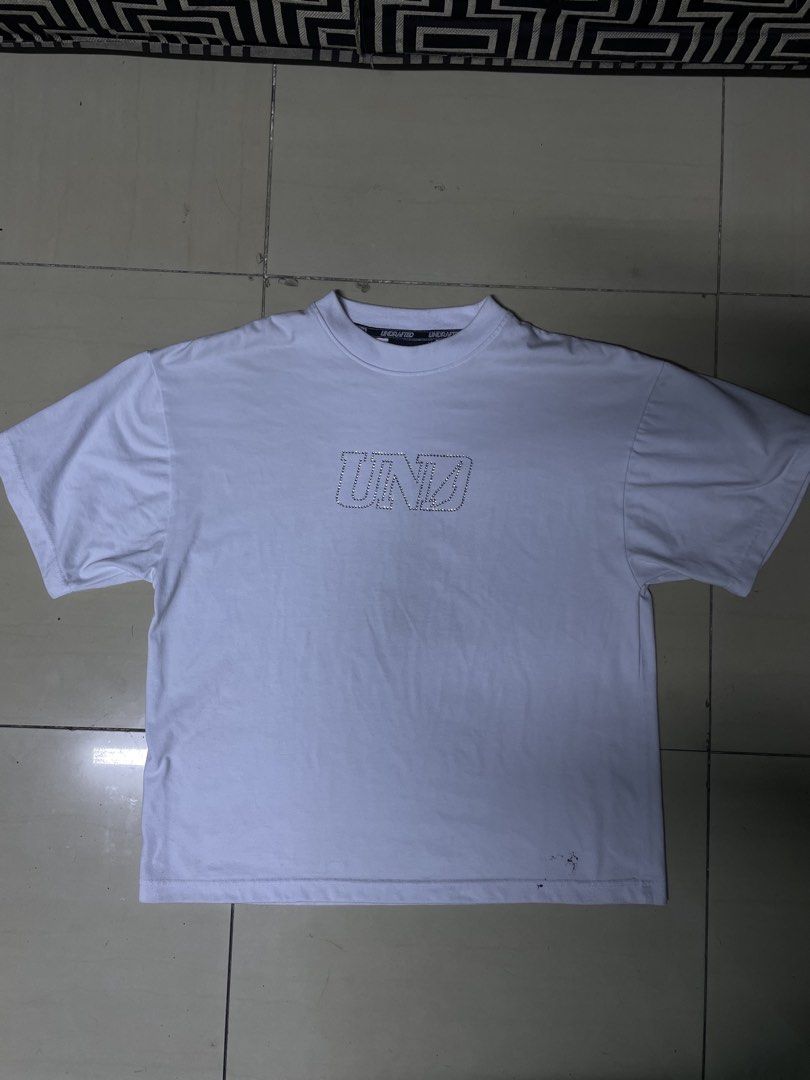 Undrafted white diamond tee size med (Category: Tshirts & Polo Shirts ) located in Manila. Submitted by truebird.f2439c (Listing ID 1463728281, Image 1). Description: - White short-sleeved t-shirt - Features a rhinestone logo with a glitch effect on the front.