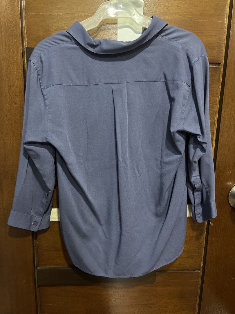 Uniqlo Blue Collared Shirt Size S (Category: Tshirts & Polo Shirts ) located in Mandaluyong City. Submitted by clothescarousel (Listing ID 1463669967, Image 3). Description: - Uniqlo collared shirt in a lovely blue shade. - Unique V-neckline with a crossover detail. - Comfortable 3/4 length sleeves. - Pleated back for a better, flattering fit. - Note: Small mark on the front, clearly shown in the last photo. - Perfect for both casual outings and 