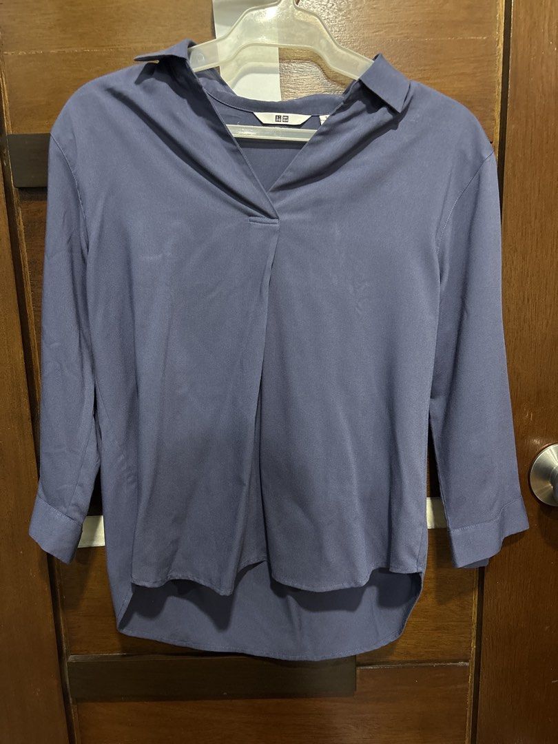 Uniqlo Blue Collared Shirt Size S (Category: Tshirts & Polo Shirts ) located in Mandaluyong City. Submitted by clothescarousel (Listing ID 1463669967, Image 1). Description: - Uniqlo collared shirt in a lovely blue shade. - Unique V-neckline with a crossover detail. - Comfortable 3/4 length sleeves. - Pleated back for a better, flattering fit. - Note: Small mark on the front, clearly shown in the last photo. - Perfect for both casual outings and 