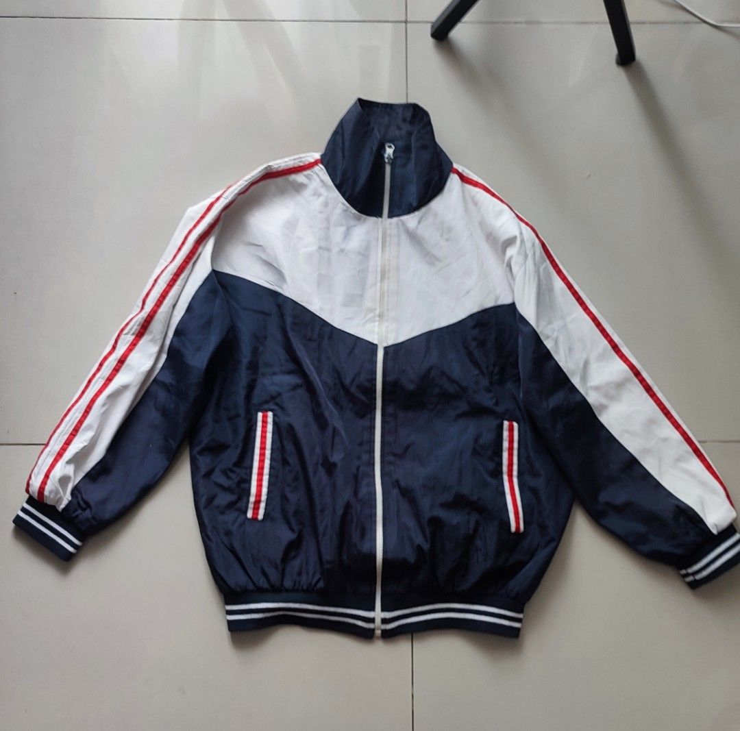 Unisex Colorblock Track Jacket (Category: Coats, Jackets and Outerwear) located in Quezon City. Submitted by rapstoreph (Listing ID 1463740980, Image 2). Description: - Stylish colorblock design: Navy blue, white, and red. - Functional zip-up front with a stand-up collar. - Comfortable ribbed cuffs and hem. - Versatile for casual wear or sports activities. - Easy to layer for different looks..