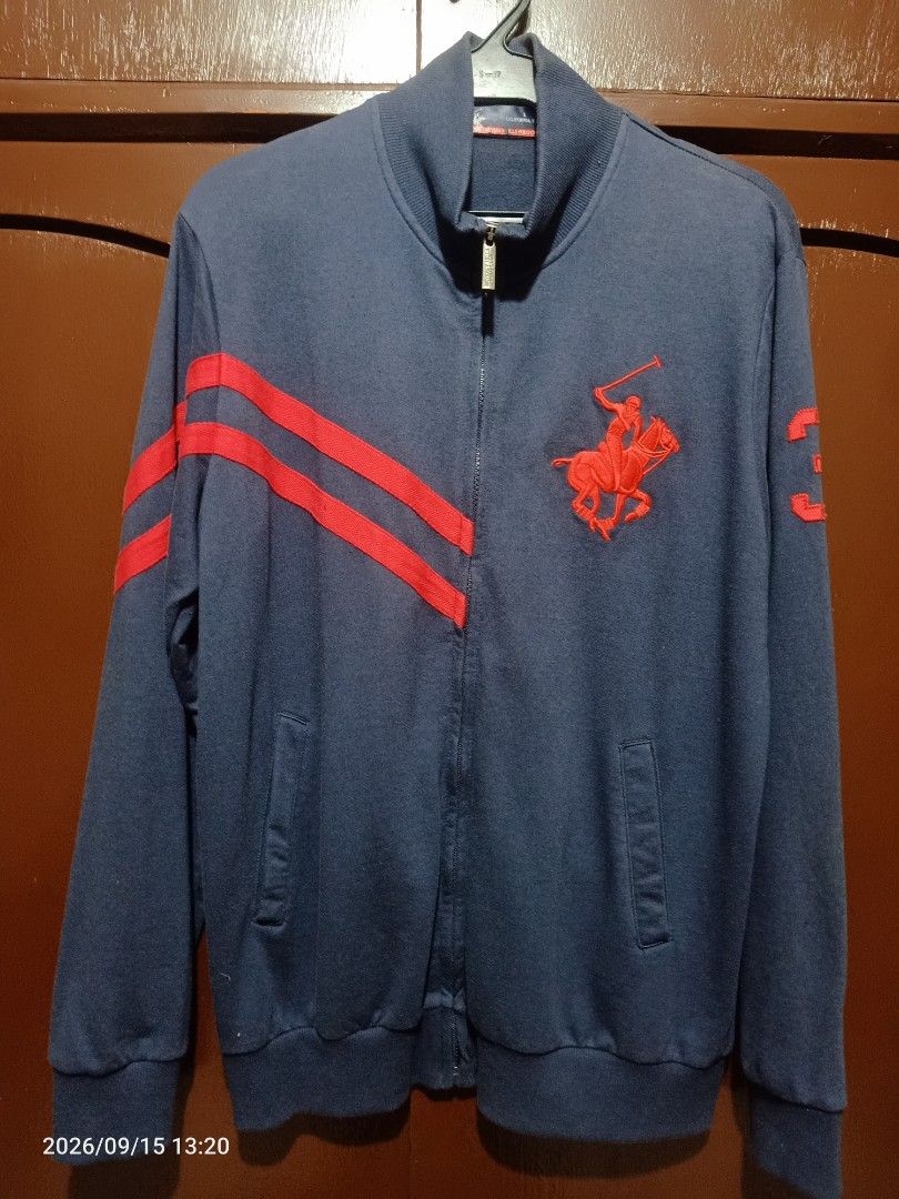 US Polo association Hoodie Jacket (Category: Coats, Jackets and Outerwear) located in Las Pinas. Submitted by OmengSoyT (Listing ID 1463645540, Image 2). Description: - Navy blue zip-up jacket - Iconic polo player logo on front - Large embroidered USA vs England Polo Cup Championship graphic on back - Liverpool, UK event detail - Red stripes on sleeves - '3' patch detail - Ideal for casual wear layering.