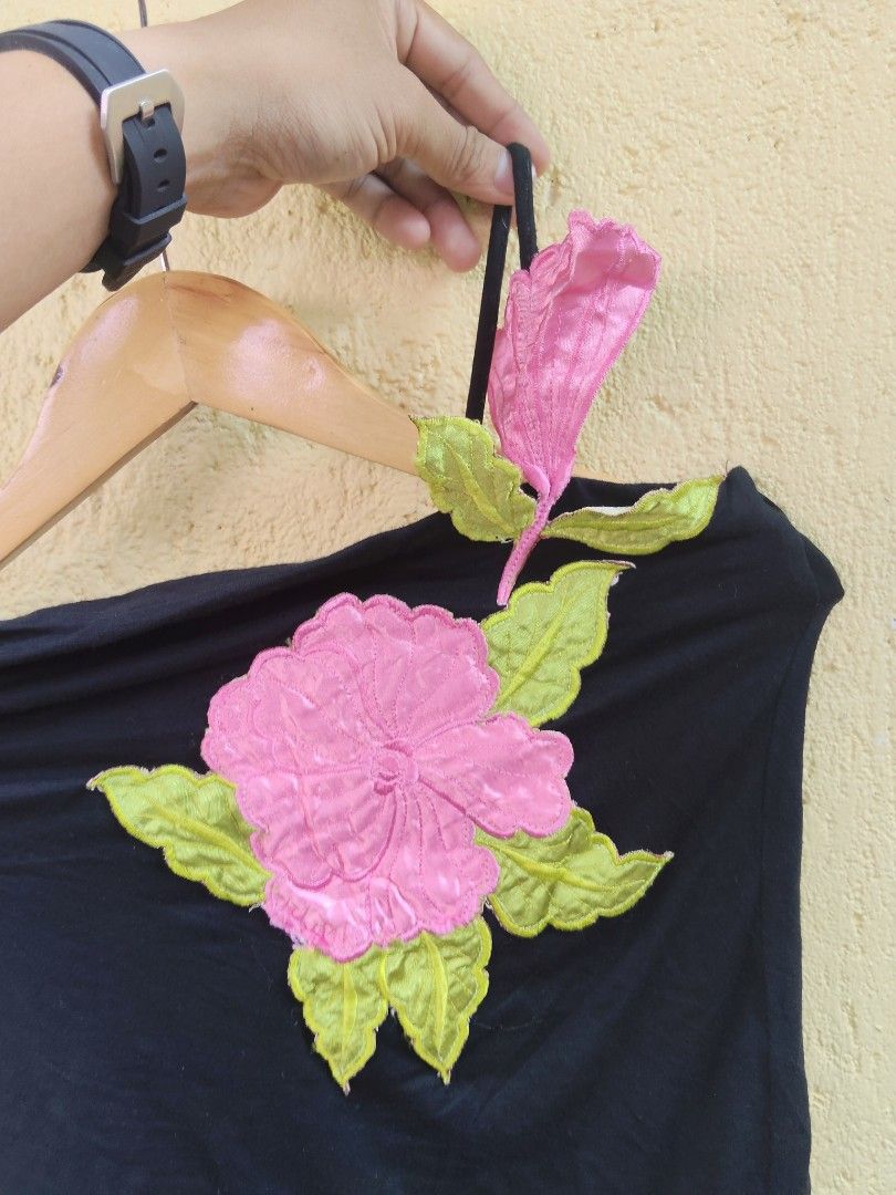 Utopia Black Off-Shoulder Top with Pink Flower Applique (Category: Sleeveless) located in City of Isabela. Submitted by jasheverything (Listing ID 1463567362, Image 2). Description: - Black off-shoulder top - Features a large pink flower applique with green leaves on the front - Thin straps - Fun and unique design - Versatile for casual wear or a night out Excellent Condition 550+SF.