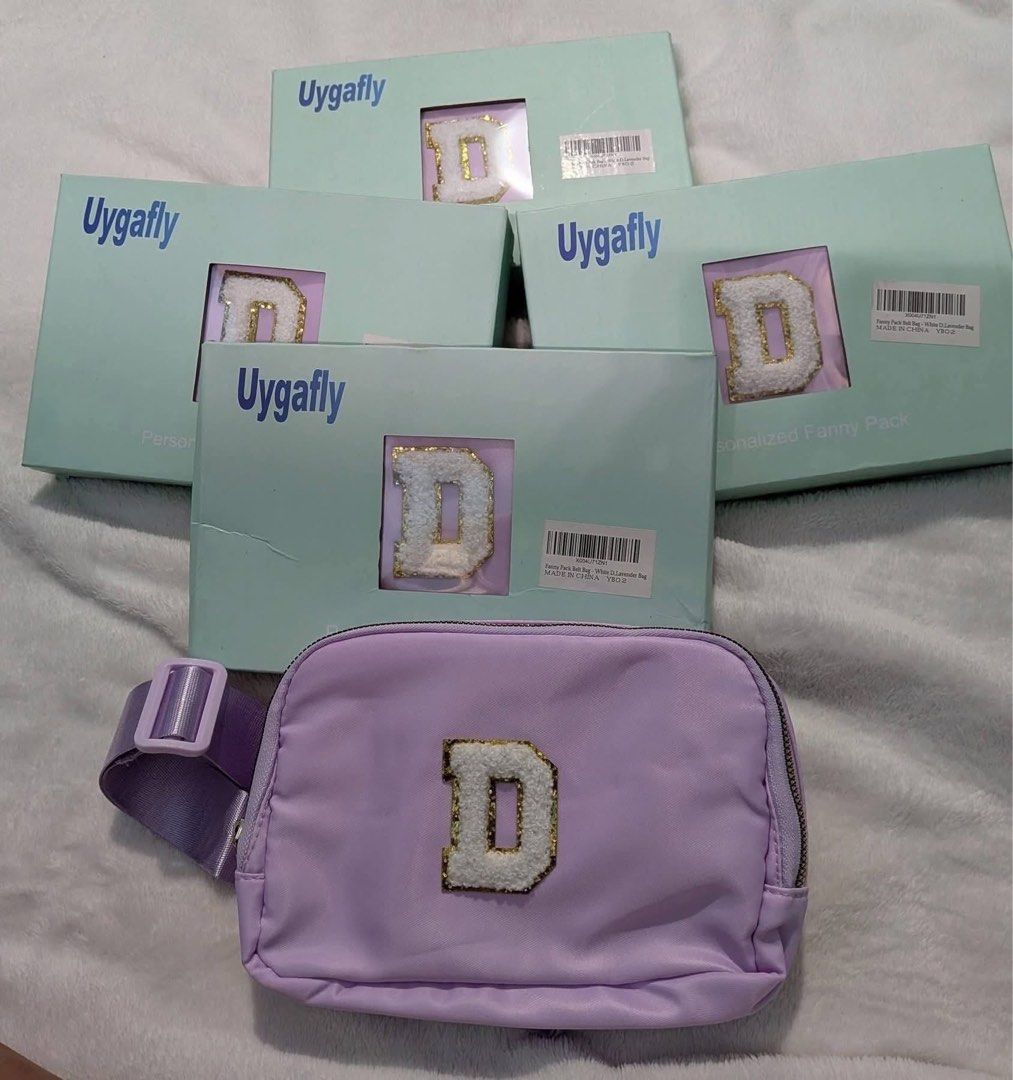 Uygafly Personalized Fanny Pack - Lavender with 'D' Initial (Category: Cross-body Bags) located in Iba. Submitted by antxjam_0707 (Listing ID 1463592163, Image 1). Description: - Cute lavender fanny pack by Uygafly - Features a fluffy white 'D' initial with gold trim - Comes in its original packaging - Adjustable strap for a comfortable, personalized fit - Ideal for carrying essentials on the go - Perfect for everyday use or travel adventures.