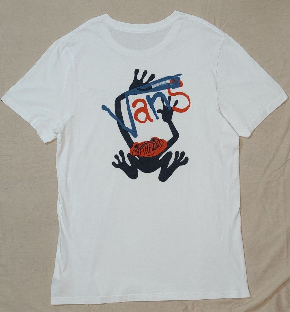 Vans White Frog Graphic T-Shirt (Category: Tshirts & Polo Shirts ) located in Bulacan. Submitted by adrian2325 (Listing ID 1463721665, Image 3). Description: - White Vans T-shirt - Features a cool frog graphic on the back - Vans logo on the front left chest - Made from comfortable cotton - Ideal for casual wear - Please check photos for detailed condition.