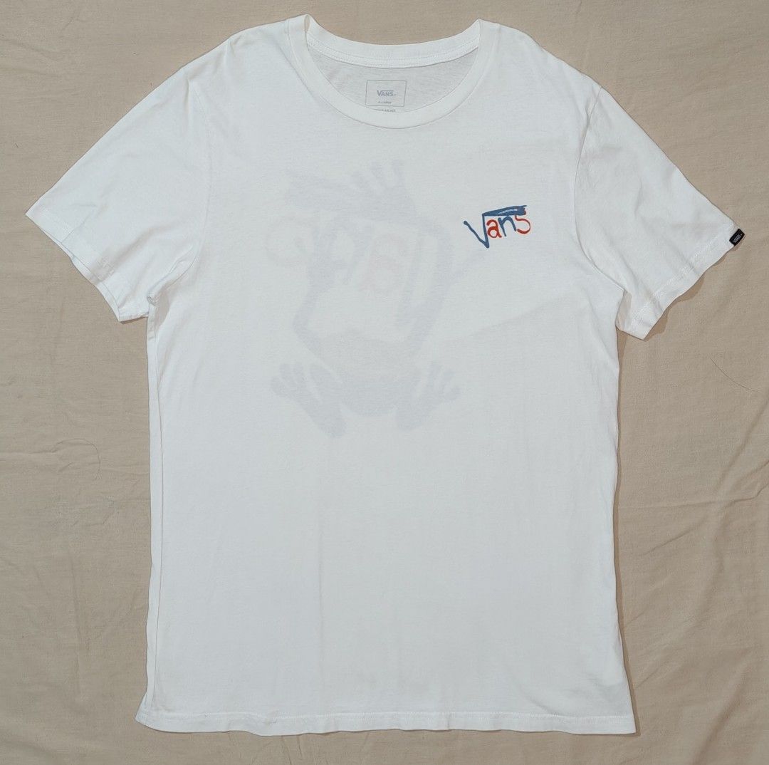 Vans White Frog Graphic T-Shirt (Category: Tshirts & Polo Shirts ) located in Bulacan. Submitted by adrian2325 (Listing ID 1463721665, Image 1). Description: - White Vans T-shirt - Features a cool frog graphic on the back - Vans logo on the front left chest - Made from comfortable cotton - Ideal for casual wear - Please check photos for detailed condition.
